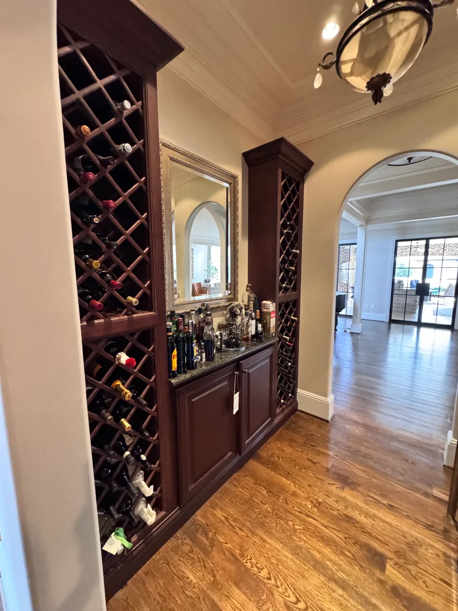Bar remodel in McGavock Farms, Brentwood. Dark White Oak Rift Sawn cabinetry, antique mirror tile, open shelving, and brass fixtures by Sebring Design Build.