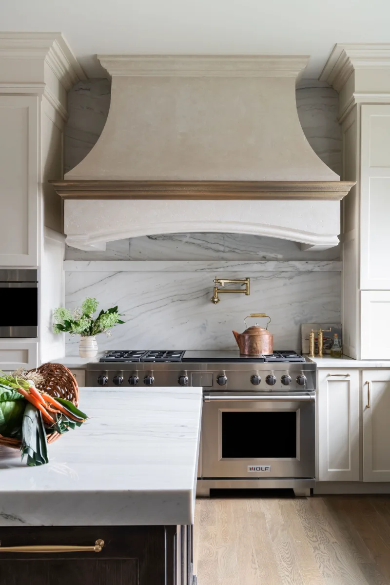 Custom kitchen remodel in McGavock Farms, Brentwood. White oak rift sawn island, Maison Blanche cabinetry, Calacatta quartz, and brass fixtures by Sebring Design Build.