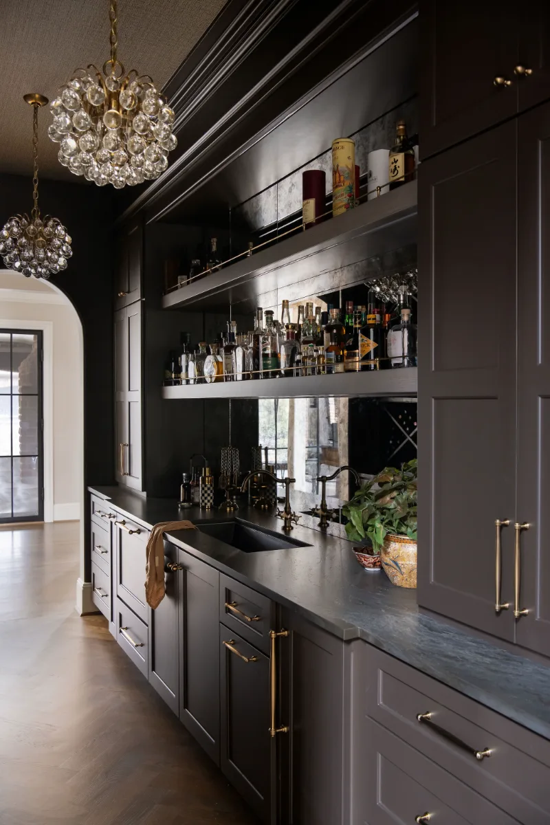 Bar remodel in McGavock Farms, Brentwood. Dark White Oak Rift Sawn cabinetry, antique mirror tile, open shelving, and brass fixtures by Sebring Design Build.