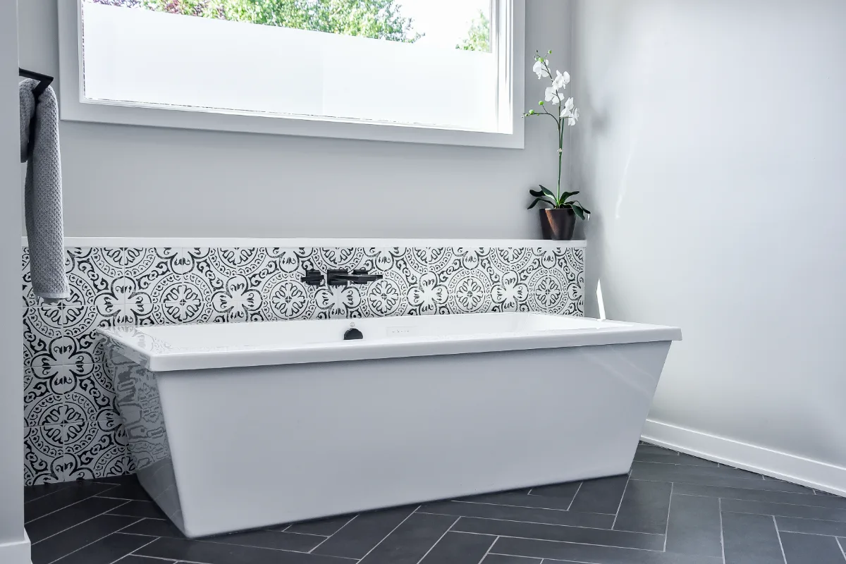 A modern-black-white primary bath remodel in Franklin, Tennessee. Bellmont Studio White cabinetry, Cambria Deligatie quartz, Kohler Pivotal Matte Black, and MSI Kenzzi Paloma accent tile by Sebring Design Build.