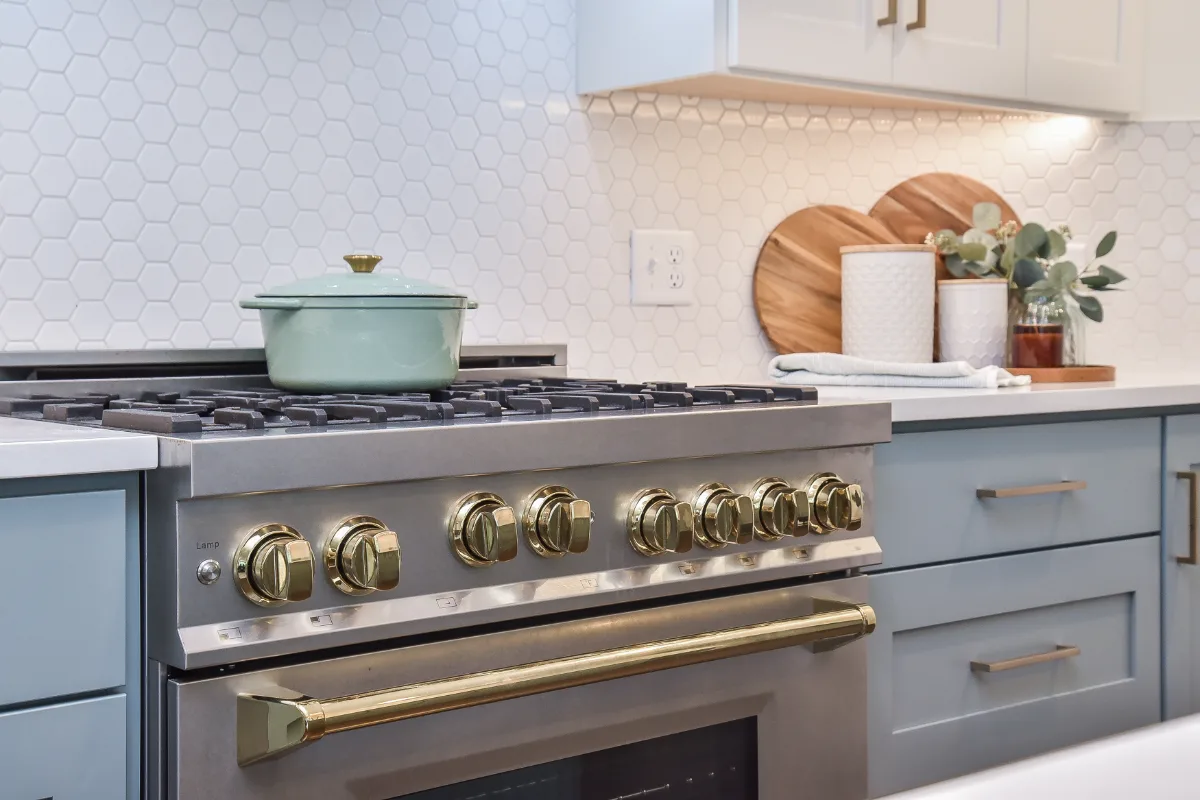 A Brentwood, TN kitchen remodel with blue and white cabinetry and gold accents. Bright, refreshing design in an interior kitchen by Sebring Design Build.