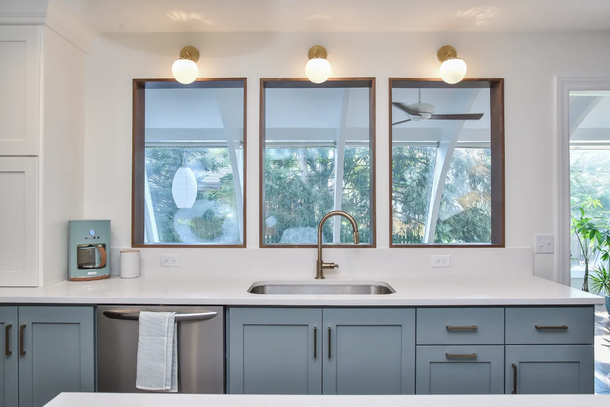 A Brentwood, TN kitchen remodel with blue and white cabinetry and gold accents. Bright, refreshing design in an interior kitchen by Sebring Design Build.