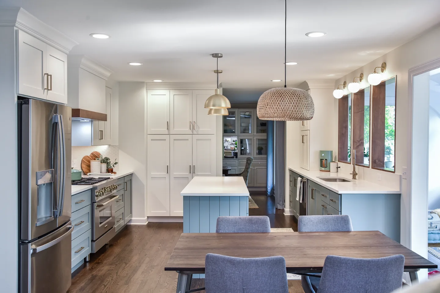 A Brentwood, TN kitchen remodel with blue and white cabinetry and gold accents. Bright, refreshing design in an interior kitchen by Sebring Design Build.