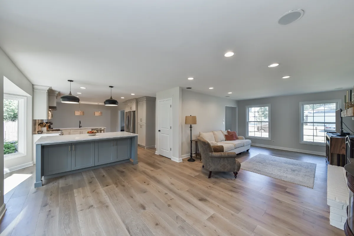 A modern-clean kitchen remodel in Franklin, TN. Soft white perimeter cabinetry, warm dune uppers, and a Puget Sound blue island by Sebring Design Build.