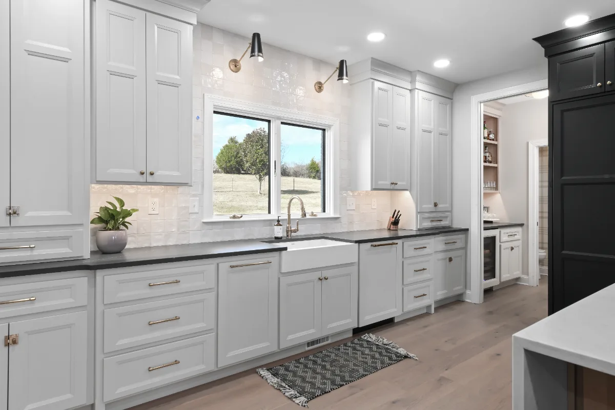 Kitchen remodel in Columbia, TN. Sebring Design Build transformed this Columbia, Tennessee kitchen with a transitional-bold design: perimeter cabinetry in Paint Grade Stone, tall cabinets in Bunker Hill Black.