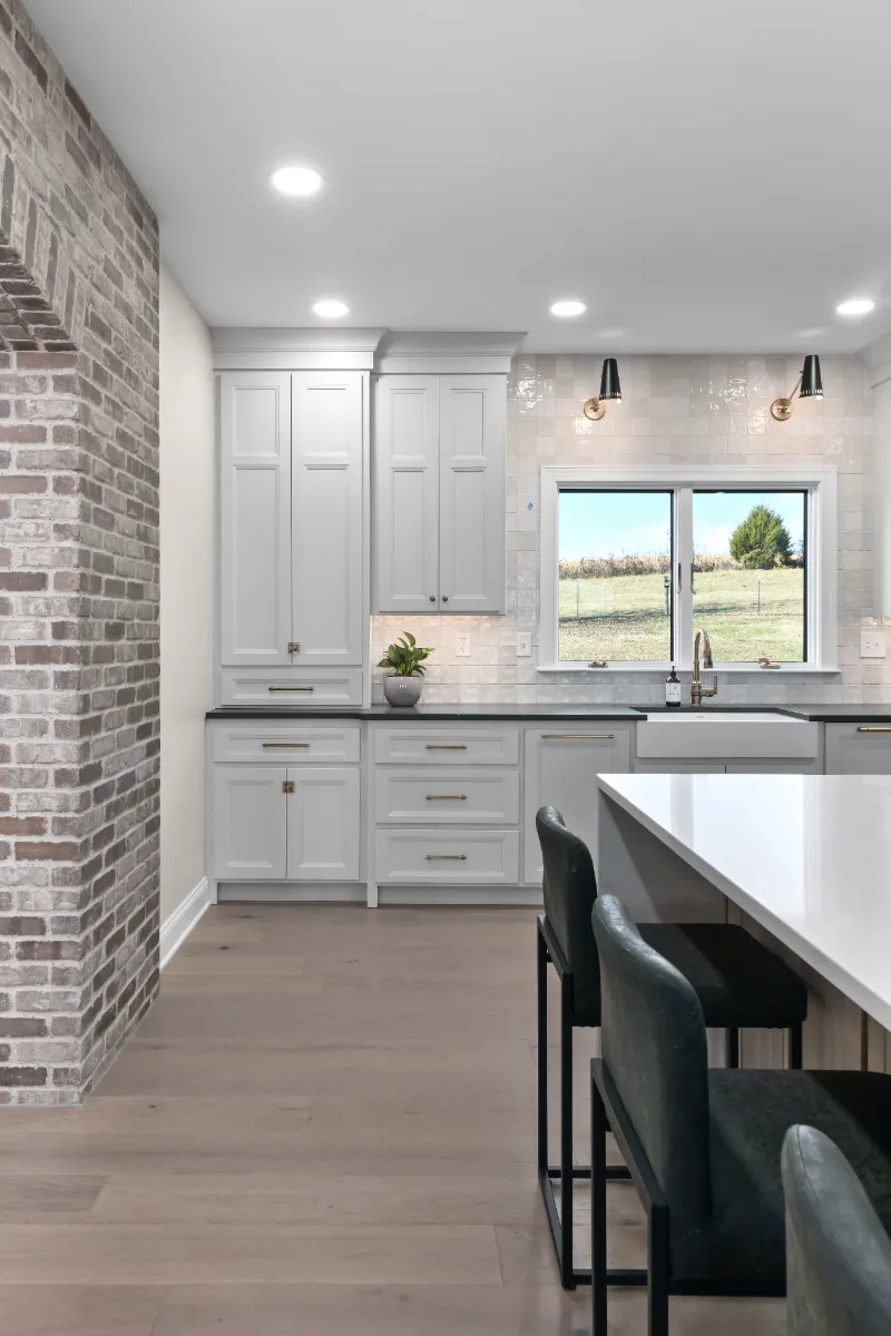 Kitchen remodel in Columbia, TN. Sebring Design Build transformed this Columbia, Tennessee kitchen with a transitional-bold design: perimeter cabinetry in Paint Grade Stone, tall cabinets in Bunker Hill Black.