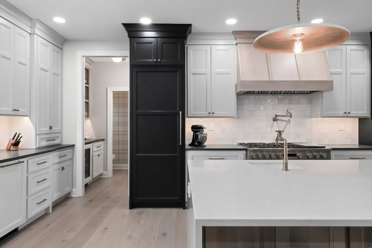 Kitchen remodel in Columbia, TN. Sebring Design Build transformed this Columbia, Tennessee kitchen with a transitional-bold design: perimeter cabinetry in Paint Grade Stone, tall cabinets in Bunker Hill Black.