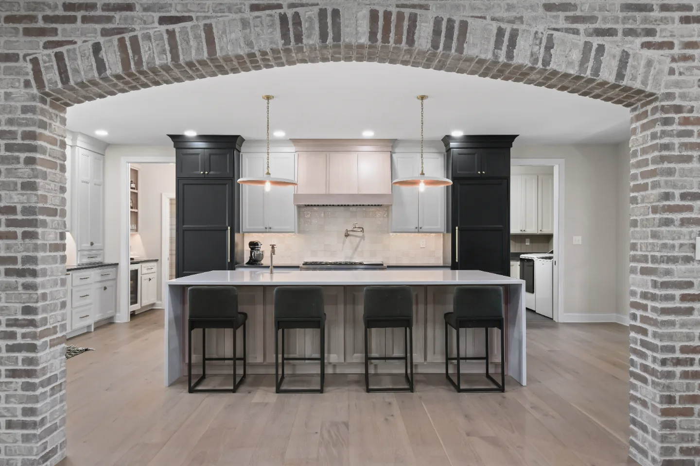 Kitchen remodel in Columbia, TN. Sebring Design Build transformed this Columbia, Tennessee kitchen with a transitional-bold design: perimeter cabinetry in Paint Grade Stone, tall cabinets in Bunker Hill Black.