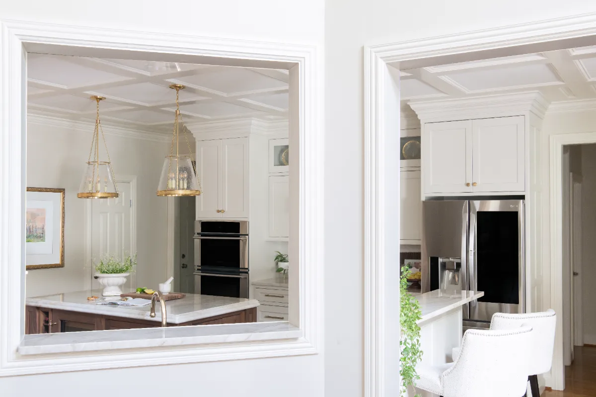 A transitional-elegant kitchen remodel in Cool Springs, Franklin, TN. Soft white cabinetry, a custom wood island, and Taj Mahal quartz by Sebring Design Build.