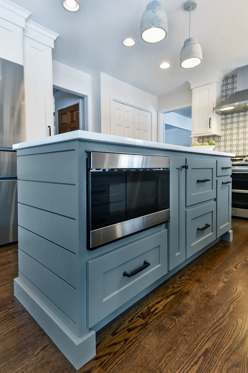 A modern farmhouse kitchen remodel in Franklin, TN. CWP cabinetry in Puget Sound and Soft White, Orion Carrara quartz, and Moen Matte Black fixtures by Sebring Design Build.