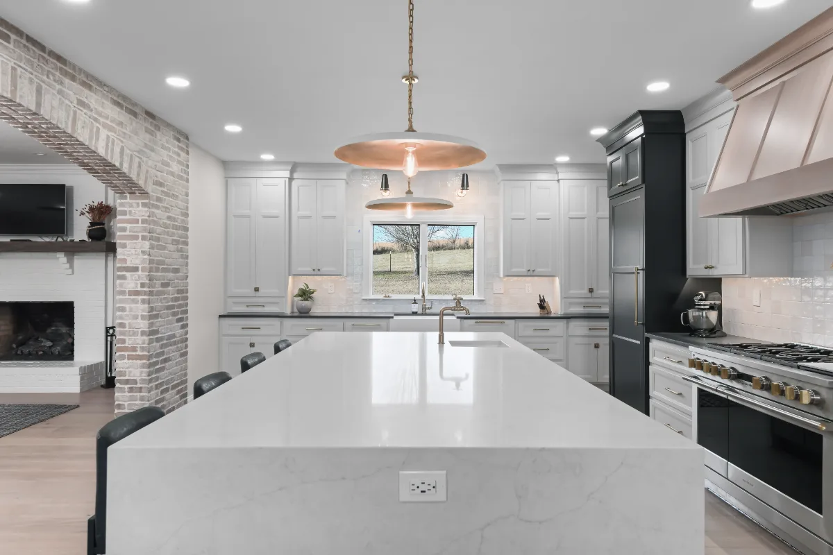A transitional-bold whole-home remodel in Columbia, TN. White Oak cabinetry, Q-Quartz surfaces, and Delta Champagne Bronze fixtures by Sebring Design Build.