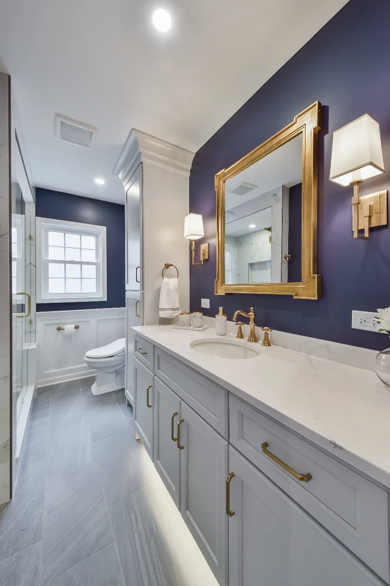 A retro-glamorous guest bath remodel in Brentwood, TN. CWP Havana Pearl cabinetry, Hanstone Yorkville quartz, and Moen Weymouth Brushed Gold fixtures by Sebring Design Build.