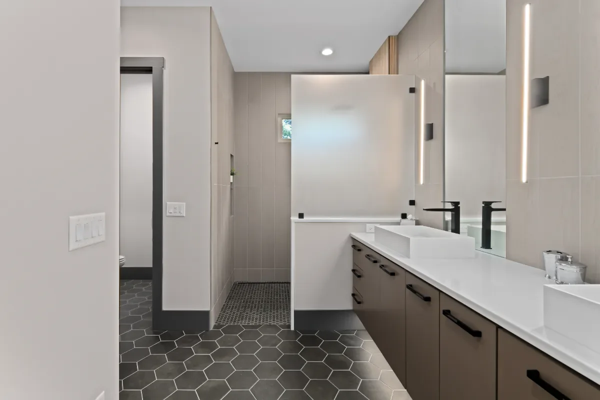 A modern-crisp primary bath remodel in Westhaven, Franklin, TN. CWP Notable Slab cabinetry in Marion Gray, polished quartz, and Hansgrohe Matte Black fixtures by Sebring Design Build.
