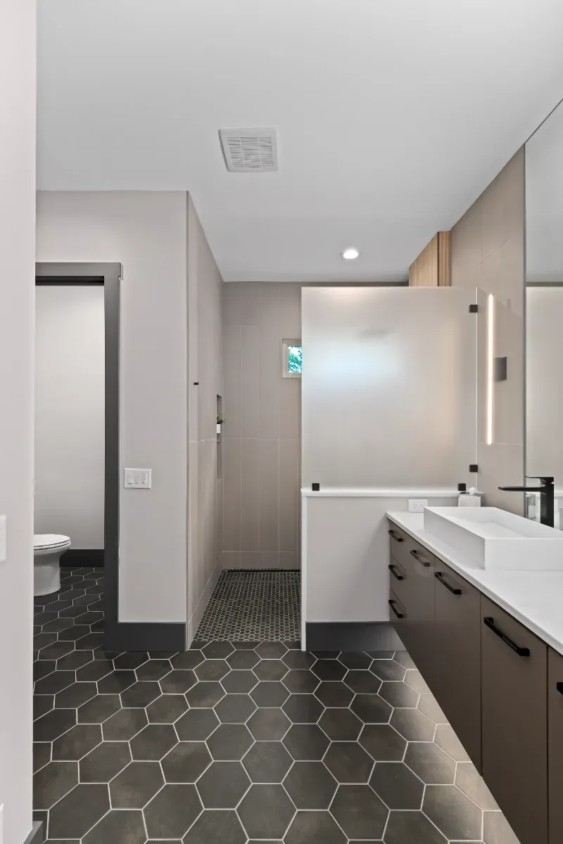 Primary Bath remodel in Westhaven, TN. Sebring Design Build transformed this Westhaven primary bath in Franklin, Tennessee with CWP Notable Slab Marion Gray cabinetry, polished quartz countertops.