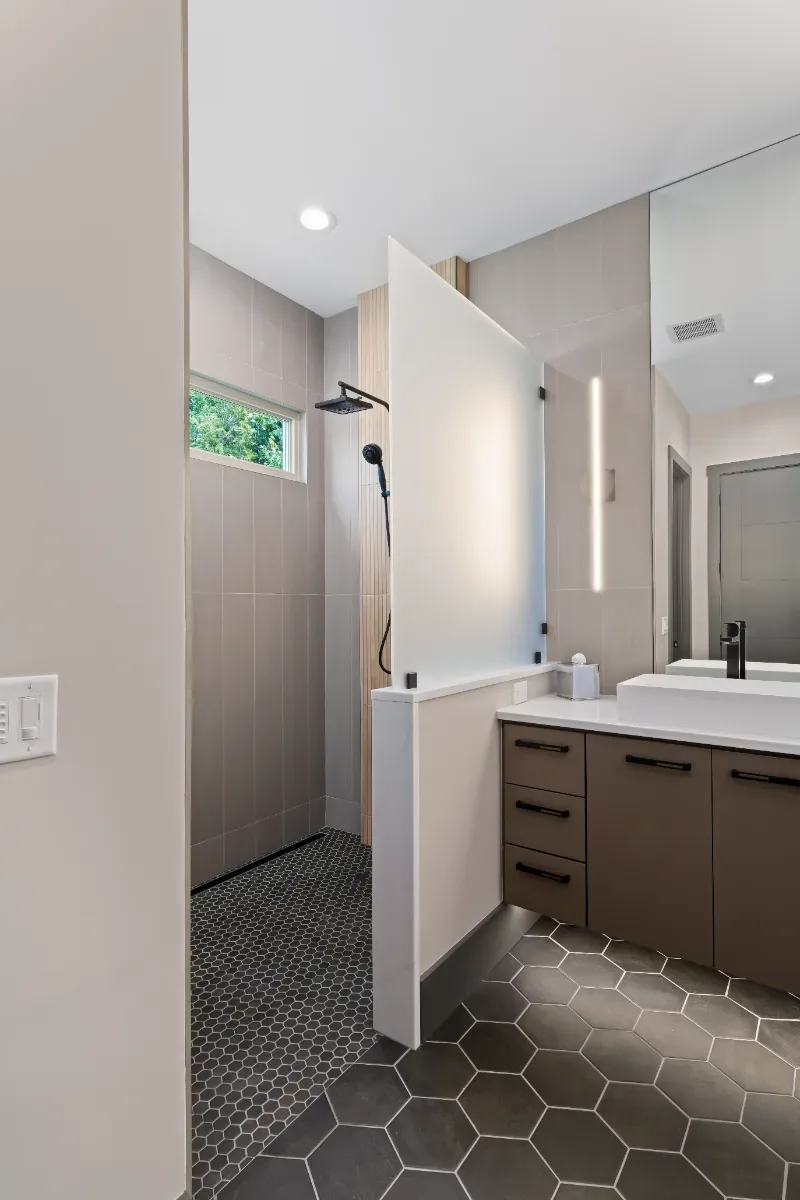 Primary Bath remodel in Westhaven, TN. Sebring Design Build transformed this Westhaven primary bath in Franklin, Tennessee with CWP Notable Slab Marion Gray cabinetry, polished quartz countertops.