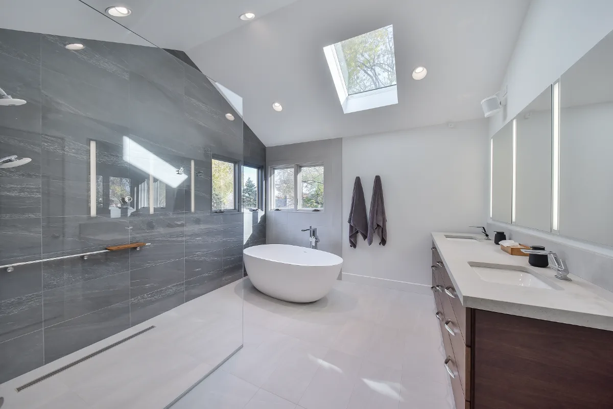 Primary Bath remodel in Franklin, TN. Sebring Design Build transformed this Franklin, Tennessee primary bath with CWP Full Overlay Walnut Ginger Slab cabinetry, CaesarStone Primordia quartz, Delta Pivotal Polished Chrome faucet.