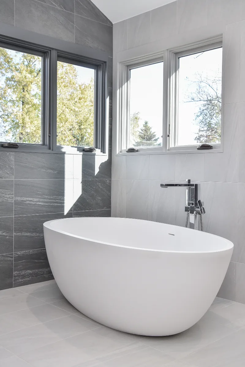 Primary Bath remodel in Franklin, TN. Sebring Design Build transformed this Franklin, Tennessee primary bath with CWP Full Overlay Walnut Ginger Slab cabinetry, CaesarStone Primordia quartz, Delta Pivotal Polished Chrome faucet.