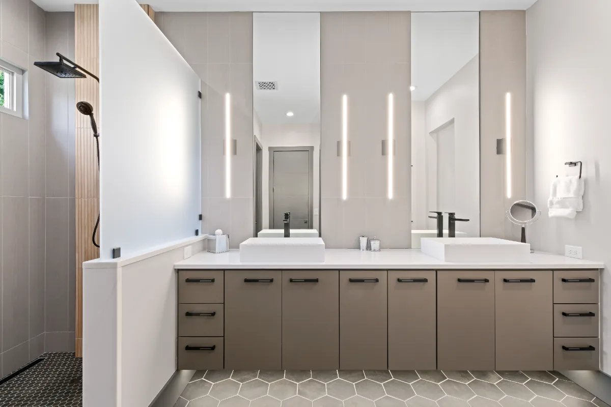 A modern-crisp primary bath remodel in Westhaven, Franklin, TN. CWP Notable Slab cabinetry in Marion Gray, polished quartz, and Hansgrohe Matte Black fixtures by Sebring Design Build.