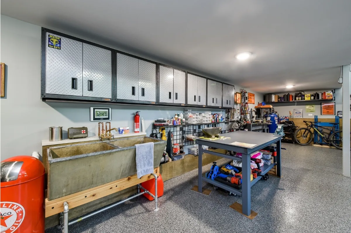A rustic-organic custom garage and loft remodel in Franklin, TN with creative car lift systems and a tinkering area by Sebring Design Build.