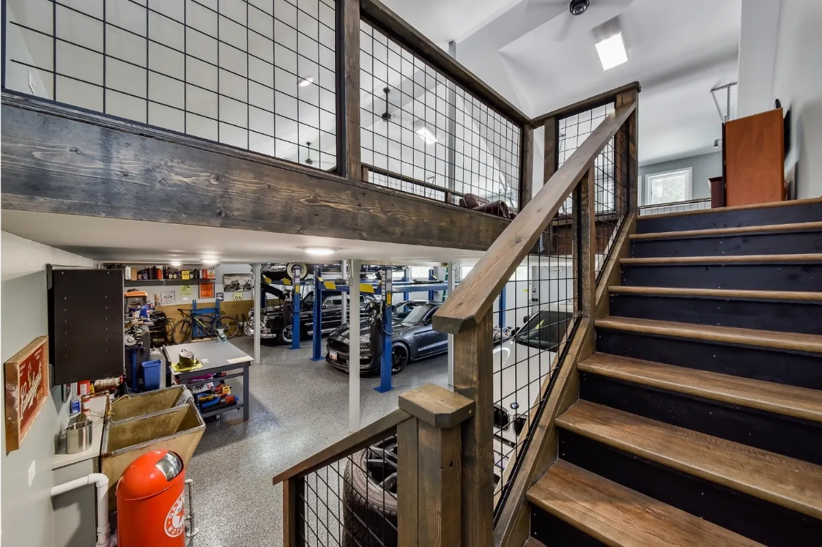 A rustic-organic custom garage and loft remodel in Franklin, TN with creative car lift systems and a tinkering area by Sebring Design Build.