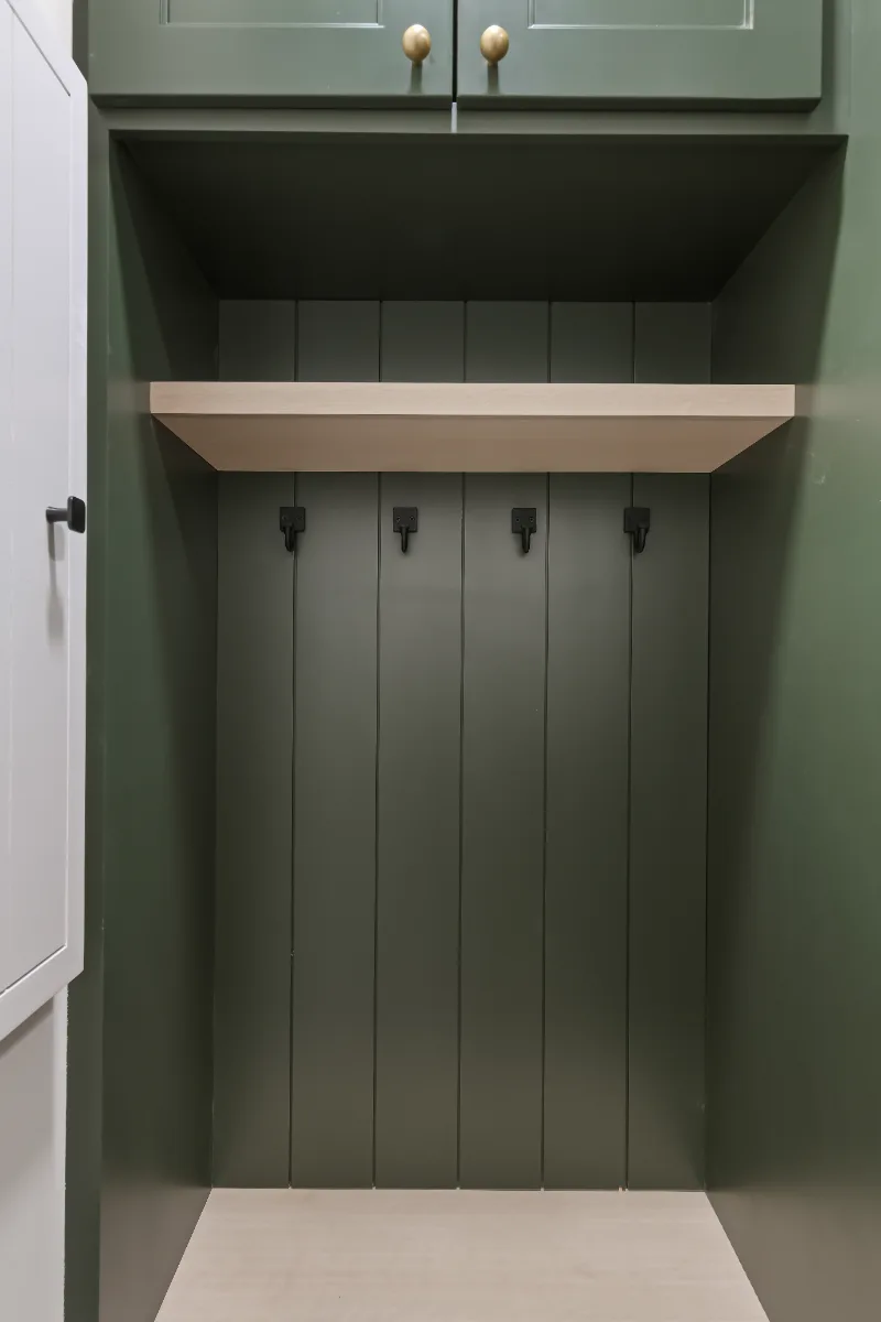 Laundry remodel in Watkins Creek, TN. Sebring Design Build transformed this Watkins Creek laundry room in Franklin, Tennessee with Ripe Olive and Champagne cabinetry, Mikado Cemento quartz, a Kohler Purist bridge faucet.