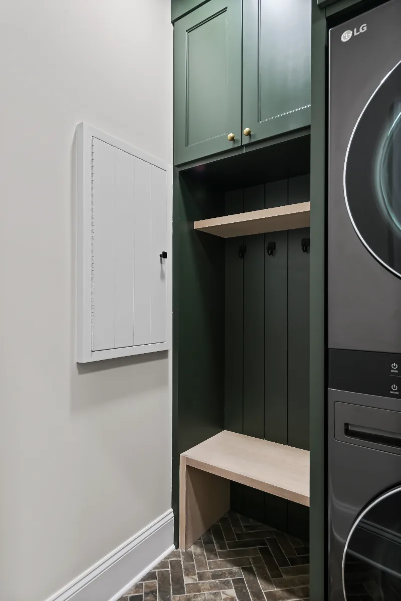 Laundry remodel in Watkins Creek, TN. Sebring Design Build transformed this Watkins Creek laundry room in Franklin, Tennessee with Ripe Olive and Champagne cabinetry, Mikado Cemento quartz, a Kohler Purist bridge faucet.