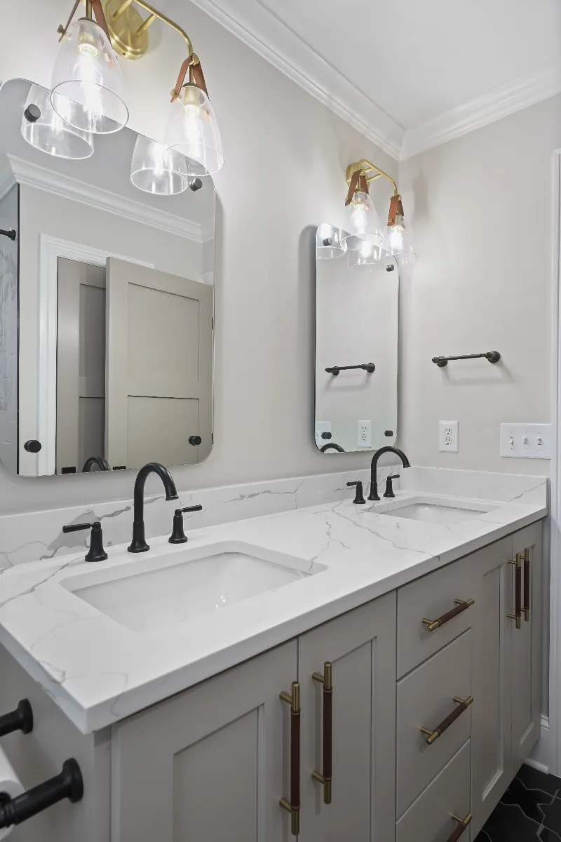 Guest Bath remodel in Watkins Creek, TN. Sebring Design Build designed this Watkins Creek guest bath (HIS) in Franklin, Tennessee with paint-grade Dune cabinetry, Mikado Calacatta Tree quartz.