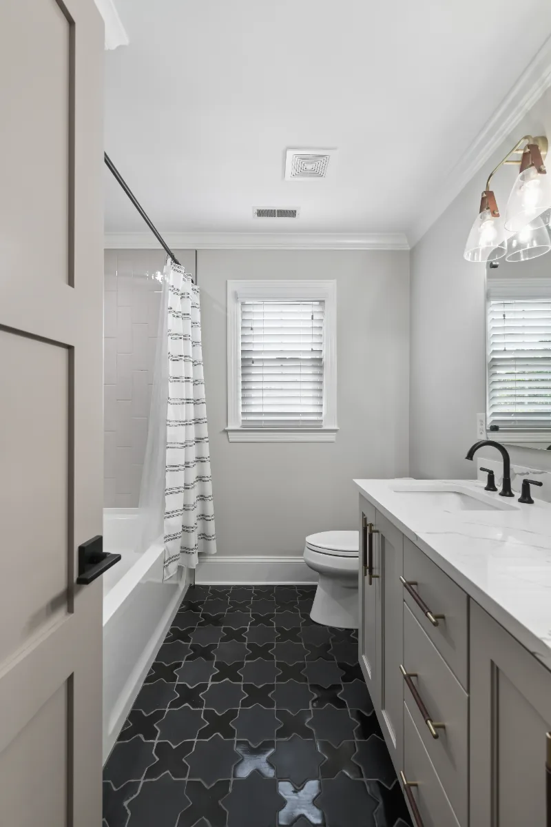 Guest Bath remodel in Watkins Creek, TN. Sebring Design Build designed this Watkins Creek guest bath (HIS) in Franklin, Tennessee with paint-grade Dune cabinetry, Mikado Calacatta Tree quartz.