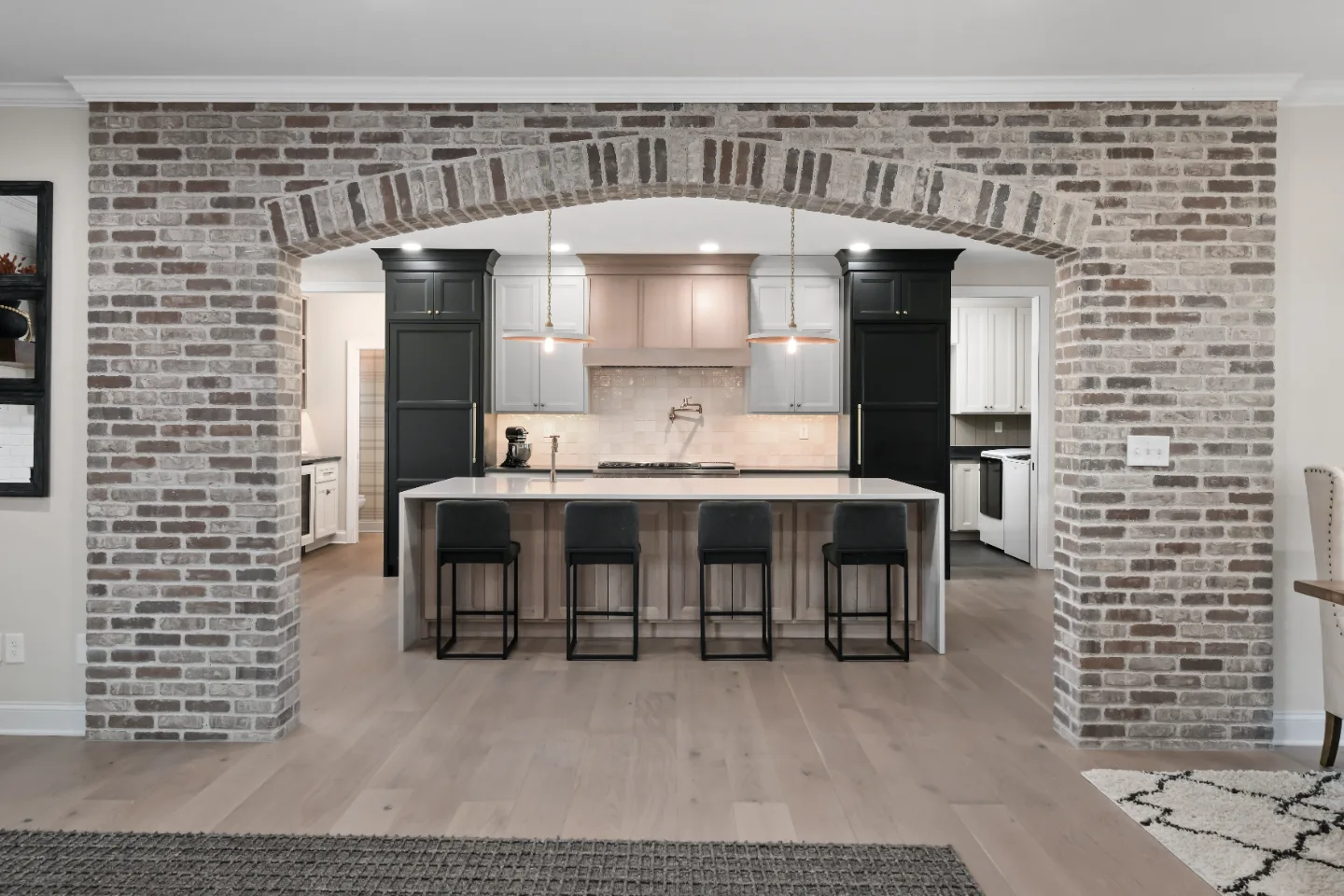 A transitional-bold whole-home remodel in Columbia, TN. White Oak cabinetry, Q-Quartz surfaces, and Delta Champagne Bronze fixtures by Sebring Design Build.