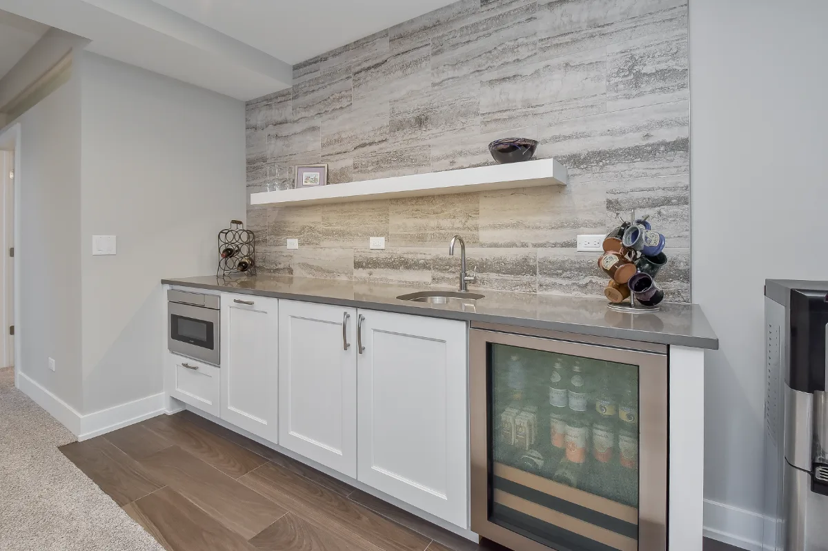 Basement remodel in Franklin, TN. Sebring Design Build finished this Franklin, Tennessee basement as a multi-zone functional-modern lower level with a main living area, gym, wet bar, guest bath, and workshop.