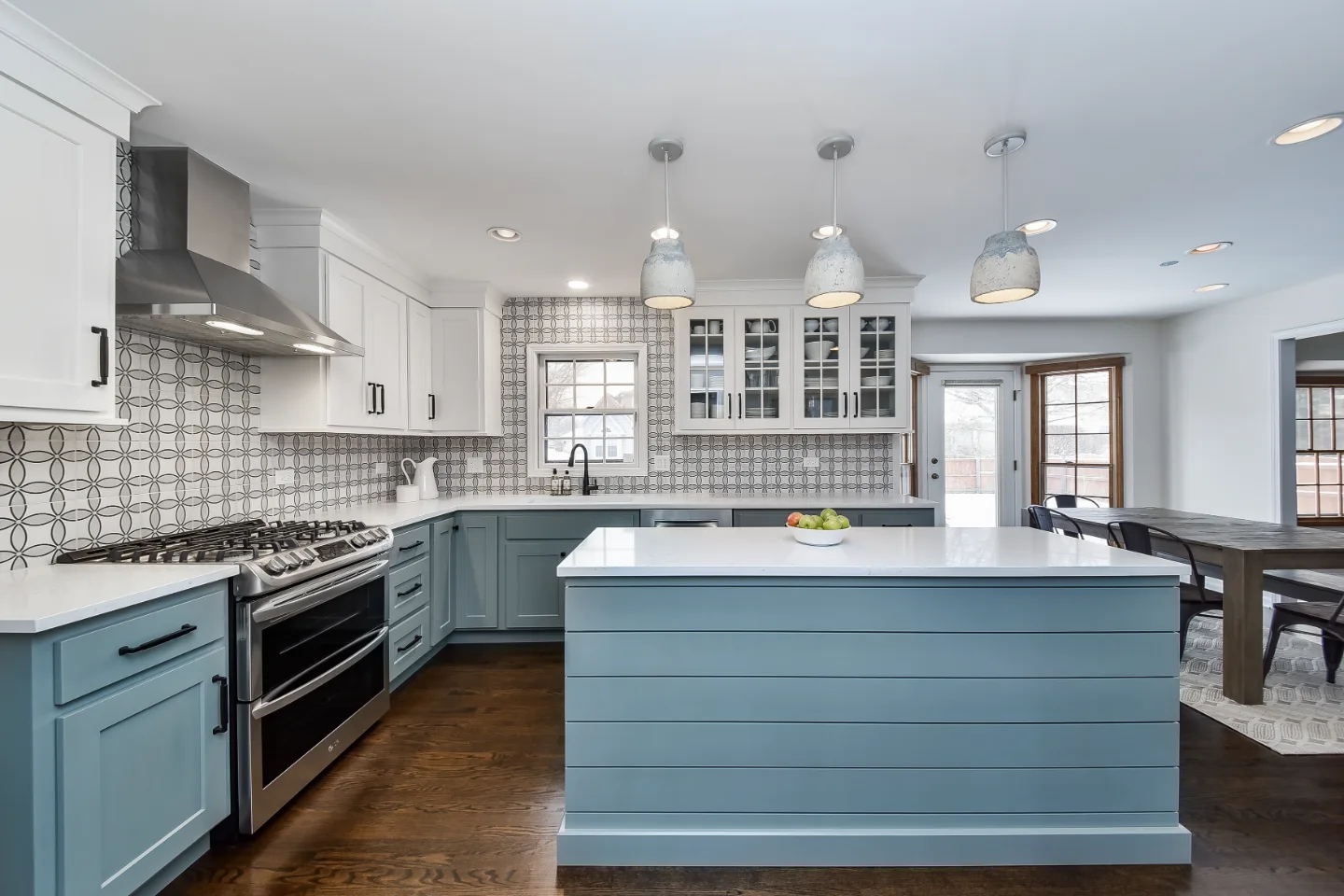 A modern farmhouse kitchen remodel in Franklin, TN. CWP cabinetry in Puget Sound and Soft White, Orion Carrara quartz, and Moen Matte Black fixtures by Sebring Design Build.