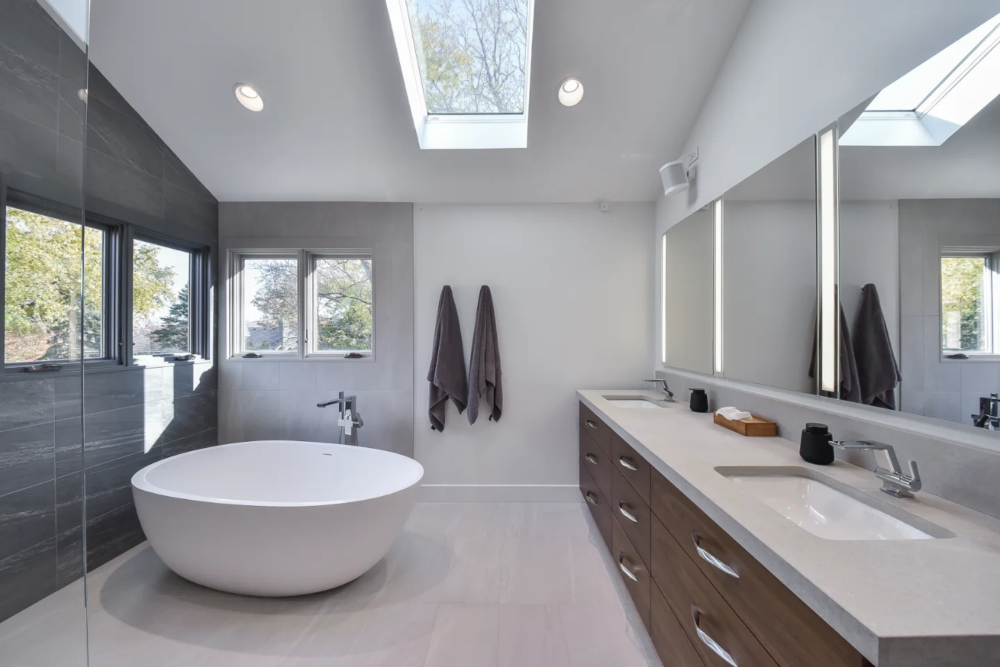 Primary Bath remodel in Franklin, TN. Sebring Design Build transformed this Franklin, Tennessee primary bath with CWP Full Overlay Walnut Ginger Slab cabinetry, CaesarStone Primordia quartz, Delta Pivotal Polished Chrome faucet.