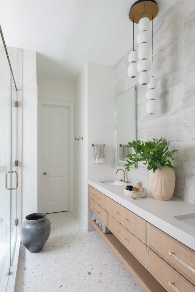 Primary Bath remodel in Westhaven, TN. Sebring Design Build designed this Westhaven primary bath to extend the home’s minimalist palette with Rift White Oak elements and MSI Calacatta Castana quartz.
