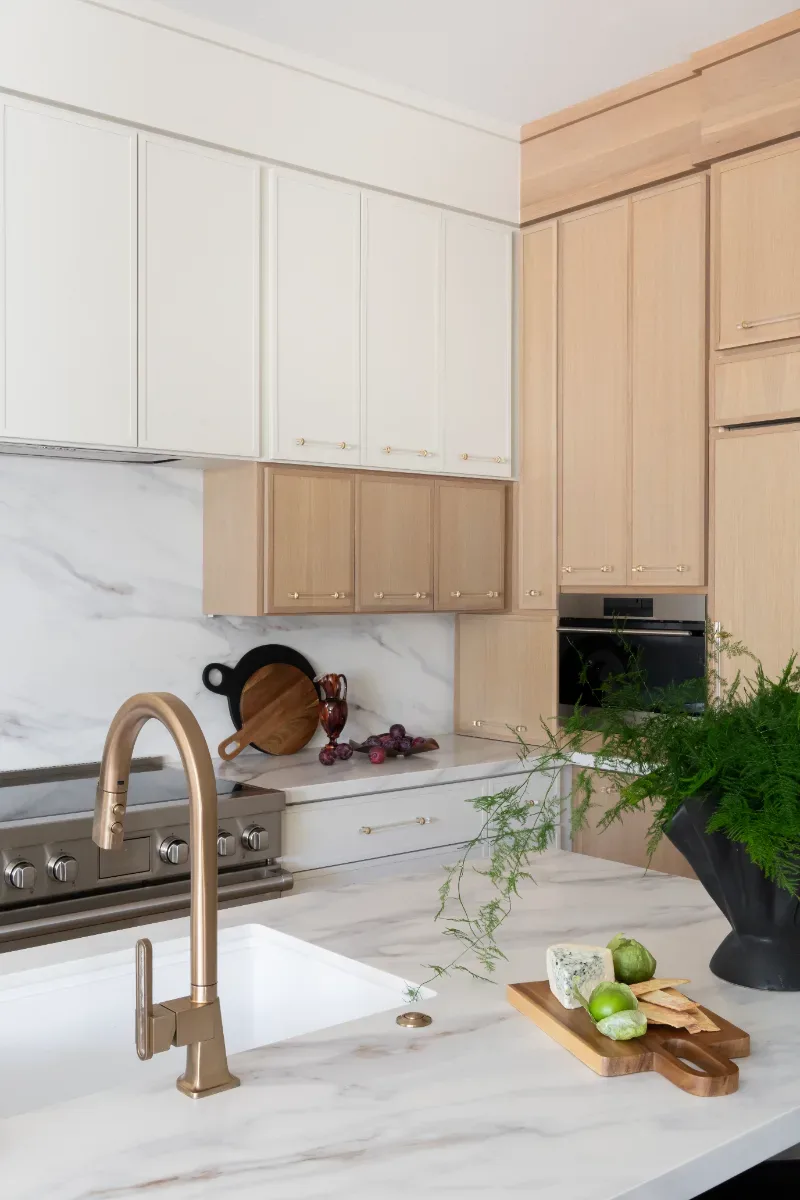Kitchen remodel in Westhaven, TN. Sebring Design Build designed this Westhaven kitchen with Konza cabinetry in Rift White Oak with a Tatami stain, MSI Calacatta Castana quartz countertops, Art & Forge Hague hardware.