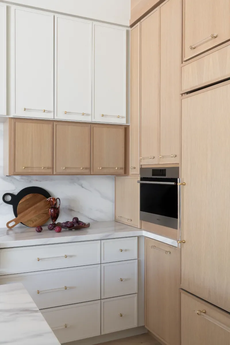 Kitchen remodel in Westhaven, TN. Sebring Design Build designed this Westhaven kitchen with Konza cabinetry in Rift White Oak with a Tatami stain, MSI Calacatta Castana quartz countertops, Art & Forge Hague hardware.