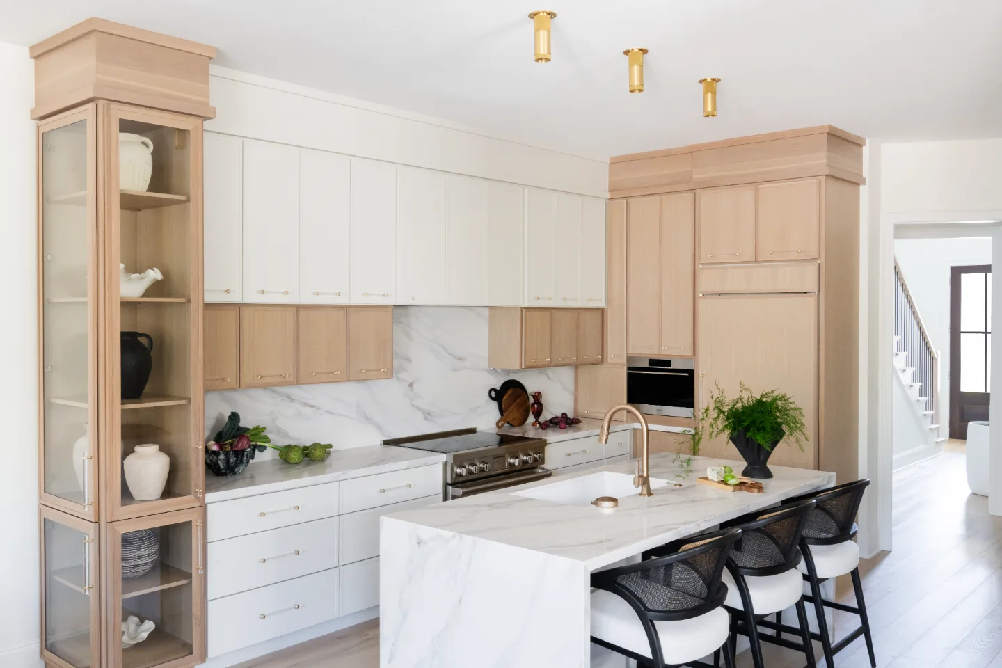 Kitchen remodel in Westhaven, TN. Sebring Design Build designed this Westhaven kitchen with Konza cabinetry in Rift White Oak with a Tatami stain, MSI Calacatta Castana quartz countertops, Art & Forge Hague hardware.