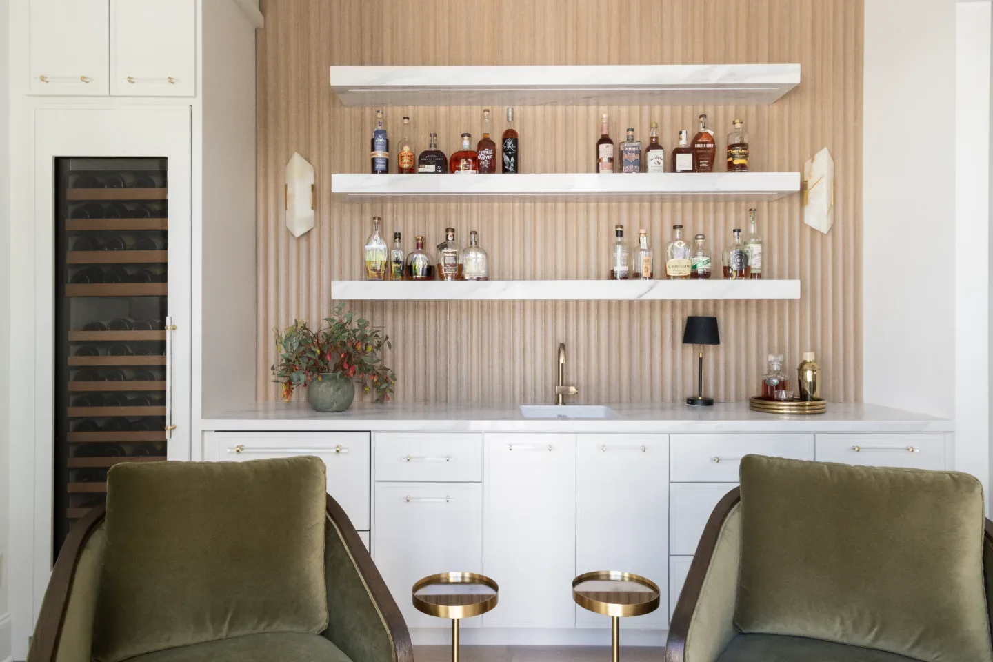 Bar remodel in Westhaven, TN. Sebring Design Build designed this Westhaven bar with MSI Calacatta Castana quartz surfaces, Rift White Oak elements, Brizo Luxe Gold fixtures, and a Franke prep sink.