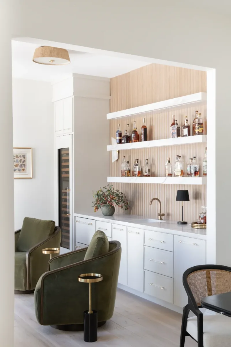 Bar remodel in Westhaven, TN. Sebring Design Build designed this Westhaven bar with MSI Calacatta Castana quartz surfaces, Rift White Oak elements, Brizo Luxe Gold fixtures, and a Franke prep sink.