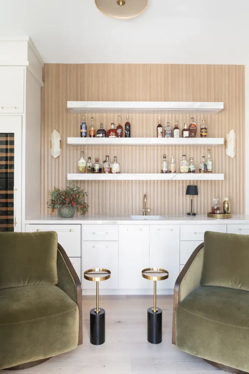 Bar remodel in Westhaven, TN. Sebring Design Build designed this Westhaven bar with MSI Calacatta Castana quartz surfaces, Rift White Oak elements, Brizo Luxe Gold fixtures, and a Franke prep sink.