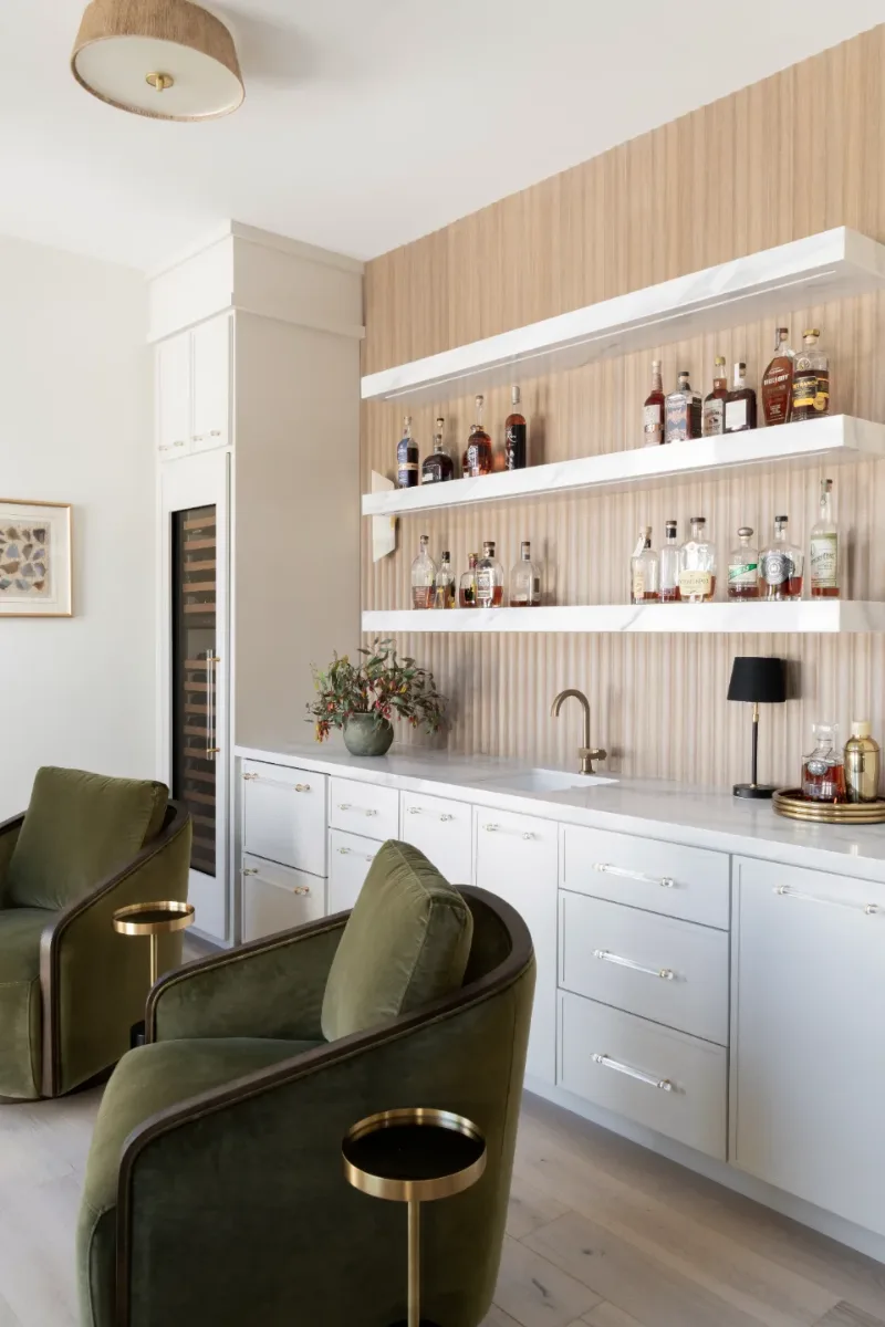 Bar remodel in Westhaven, TN. Sebring Design Build designed this Westhaven bar with MSI Calacatta Castana quartz surfaces, Rift White Oak elements, Brizo Luxe Gold fixtures, and a Franke prep sink.