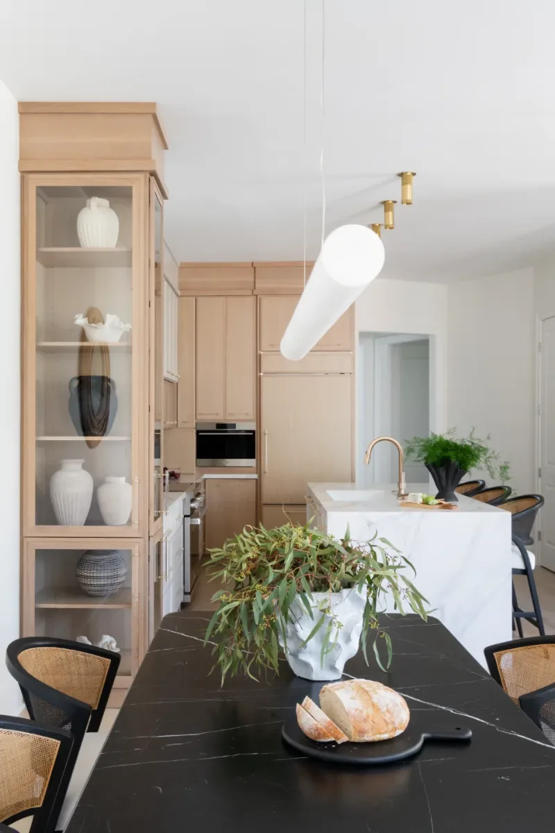 Dining Room remodel in Westhaven, TN. Sebring Design Build designed this Westhaven dining room to extend the kitchen’s minimalist palette with Rift White Oak elements, MSI Calacatta Castana quartz accents.