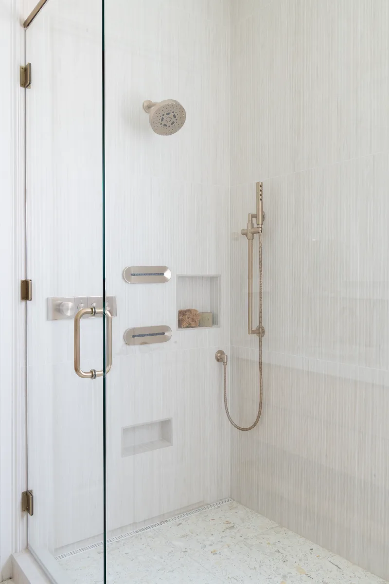 Primary Bath remodel in Westhaven, TN. Sebring Design Build designed this Westhaven primary bath to extend the home’s minimalist palette with Rift White Oak elements and MSI Calacatta Castana quartz.