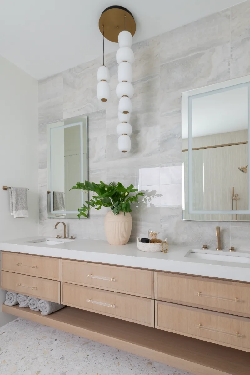 Primary Bath remodel in Westhaven, TN. Sebring Design Build designed this Westhaven primary bath to extend the home’s minimalist palette with Rift White Oak elements and MSI Calacatta Castana quartz.