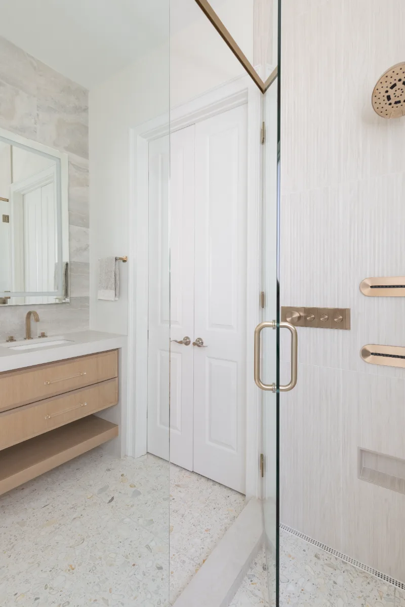 Primary Bath remodel in Westhaven, TN. Sebring Design Build designed this Westhaven primary bath to extend the home’s minimalist palette with Rift White Oak elements and MSI Calacatta Castana quartz.