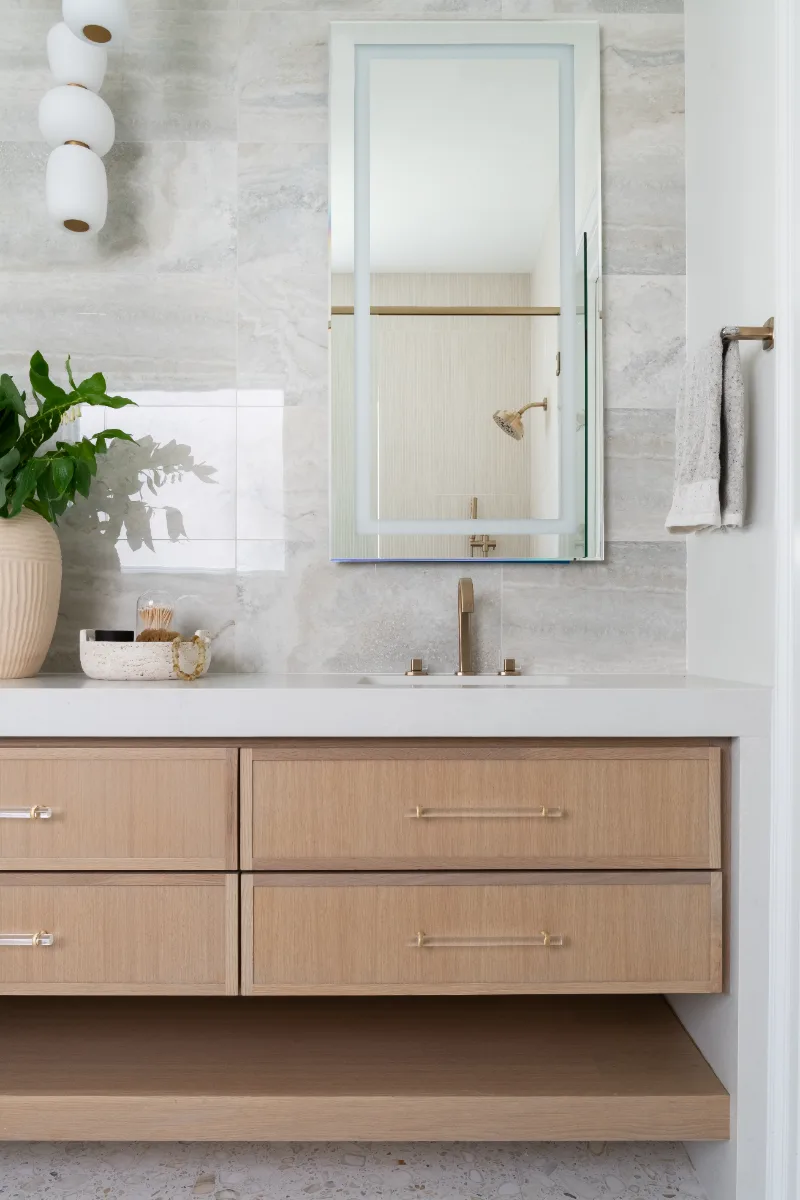Primary Bath remodel in Westhaven, TN. Sebring Design Build designed this Westhaven primary bath to extend the home’s minimalist palette with Rift White Oak elements and MSI Calacatta Castana quartz.