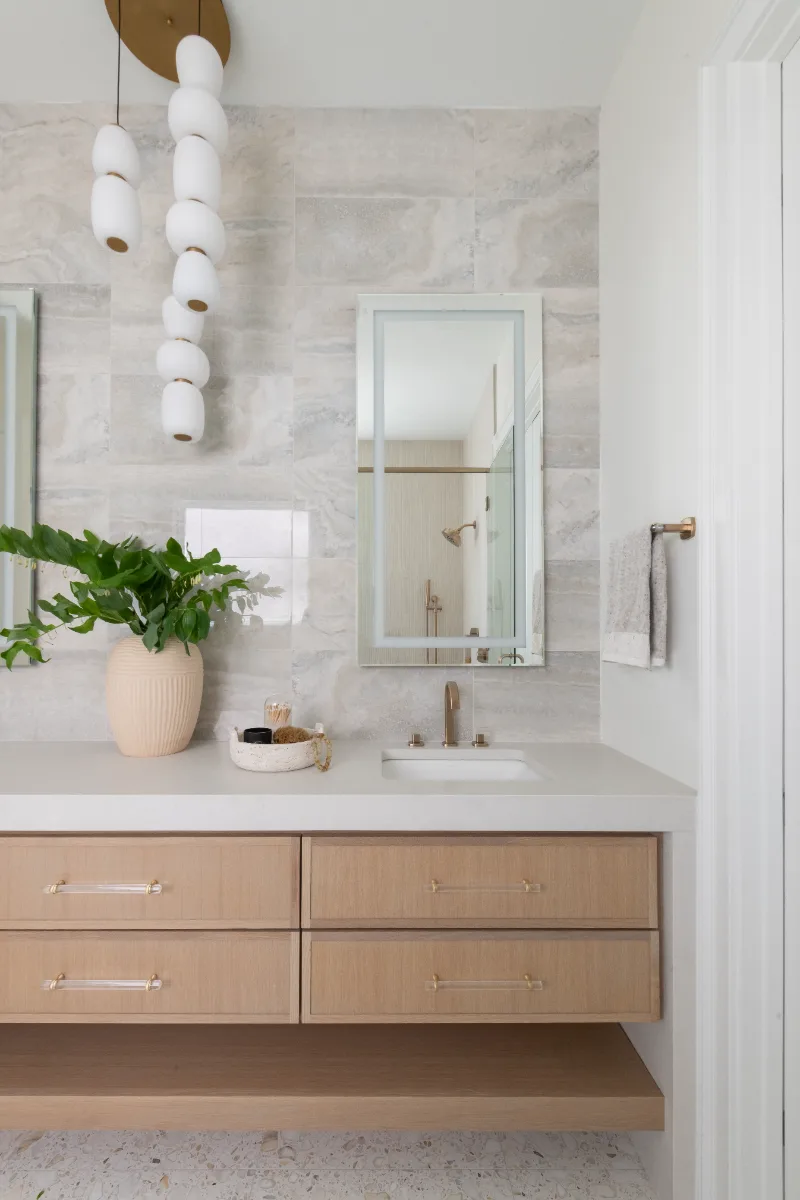 Primary Bath remodel in Westhaven, TN. Sebring Design Build designed this Westhaven primary bath to extend the home’s minimalist palette with Rift White Oak elements and MSI Calacatta Castana quartz.