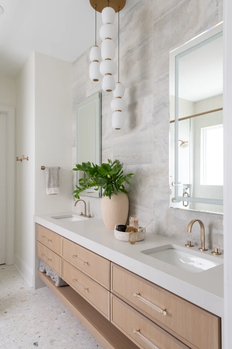 Primary Bath remodel in Westhaven, TN. Sebring Design Build designed this Westhaven primary bath to extend the home’s minimalist palette with Rift White Oak elements and MSI Calacatta Castana quartz.