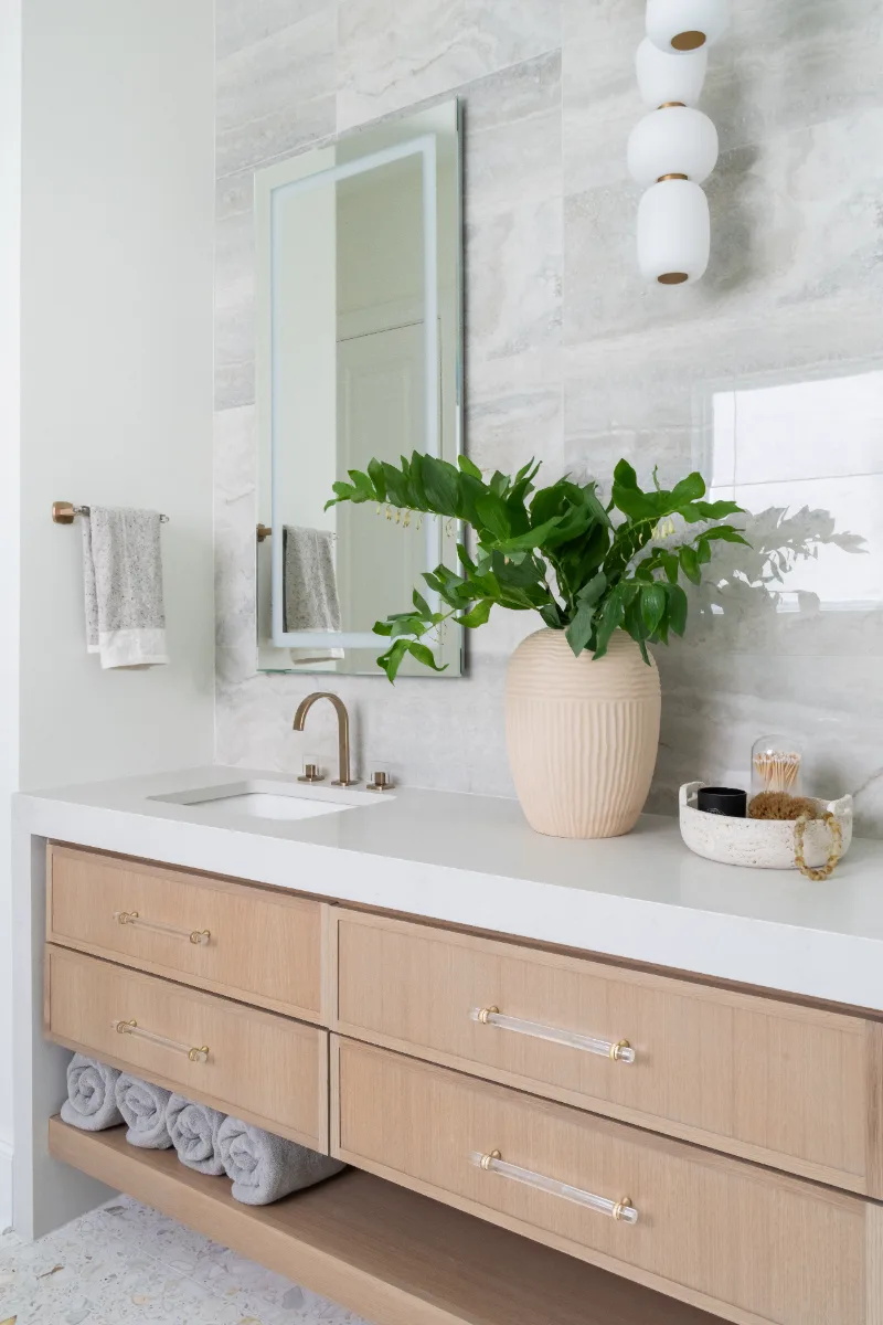 Primary Bath remodel in Westhaven, TN. Sebring Design Build designed this Westhaven primary bath to extend the home’s minimalist palette with Rift White Oak elements and MSI Calacatta Castana quartz.