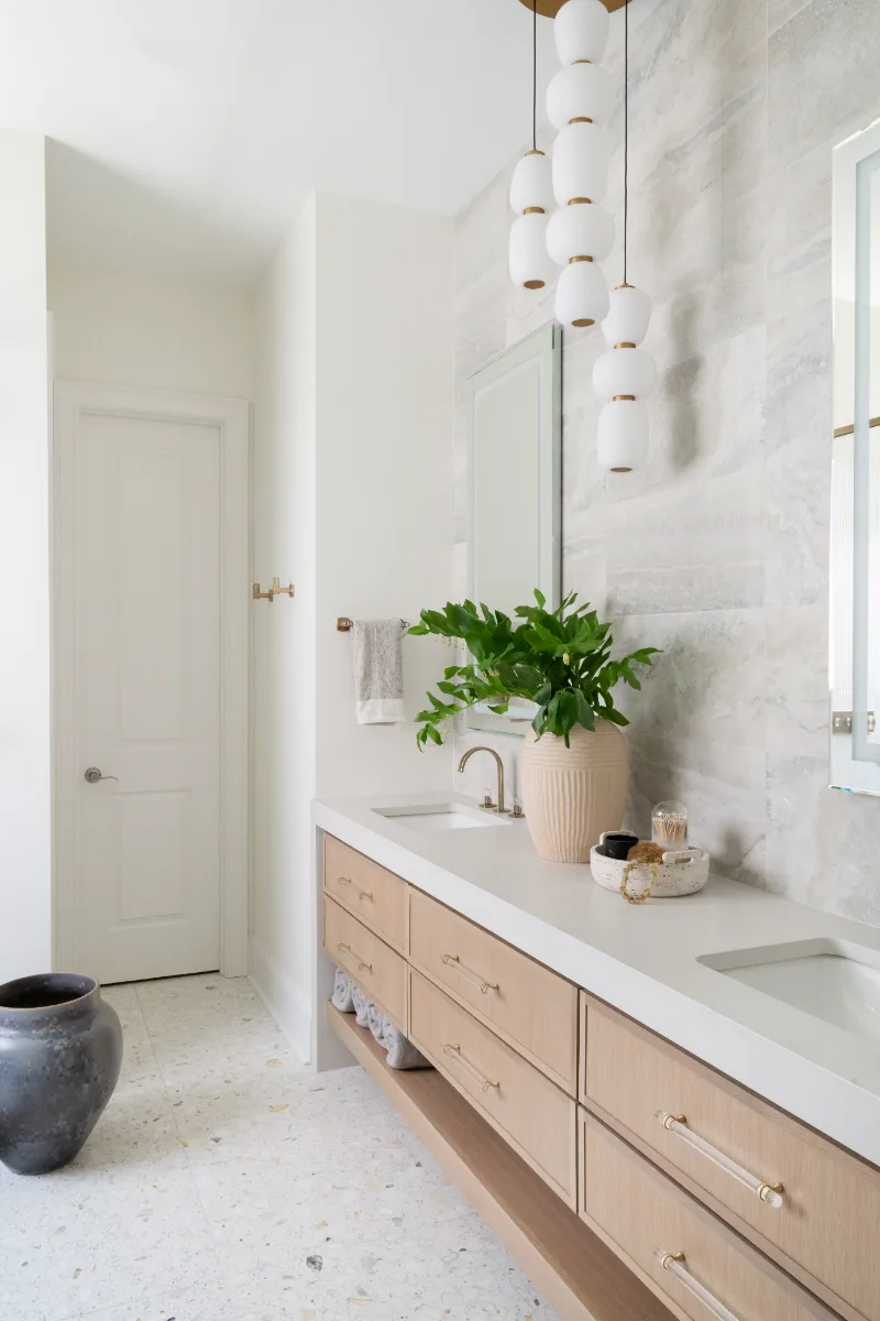Primary Bath remodel in Westhaven, TN. Sebring Design Build designed this Westhaven primary bath to extend the home’s minimalist palette with Rift White Oak elements and MSI Calacatta Castana quartz.