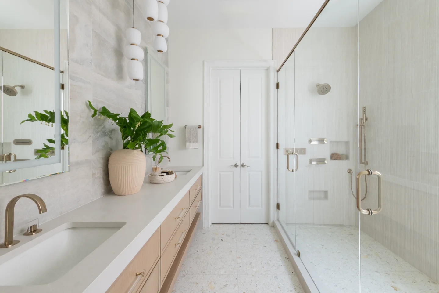 Primary Bath remodel in Westhaven, TN. Sebring Design Build designed this Westhaven primary bath to extend the home’s minimalist palette with Rift White Oak elements and MSI Calacatta Castana quartz.
